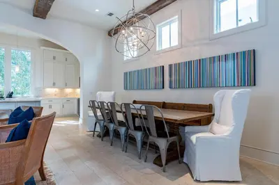 a kitchen and dining room with a table and chairs at Kidd Cottage in Rosemary Beach