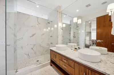 a bathroom with two sinks and a shower at Kingston Beach Club in Rosemary Beach
