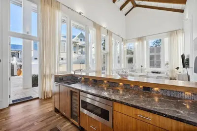 a kitchen with a large sink and a large window at Kingston Beach Club in Rosemary Beach