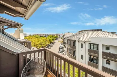 a balcony with a view of a street and buildings at Blue Oak in Rosemary Beach