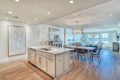 a kitchen and dining room with a sink and a table at The Georgetown 403 in Rosemary Beach