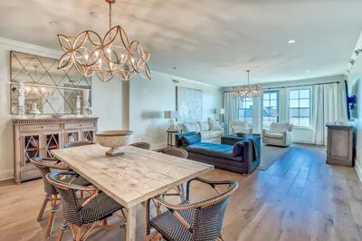 a living room with a table and chairs at The Georgetown 403 in Rosemary Beach
