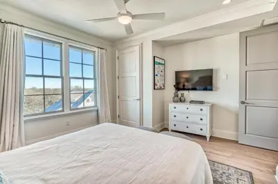 a bedroom with a bed and a window at The Georgetown 403 in Rosemary Beach