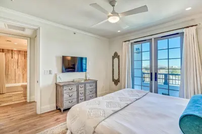 a bedroom with a bed and a large window at The Georgetown 403 in Rosemary Beach