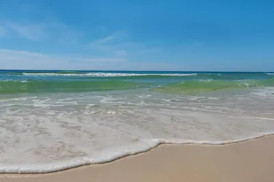 a sandy beach with the ocean in the background at Benoit Carriage House in Rosemary Beach