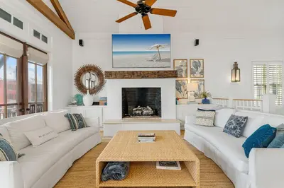 a living room with white furniture and a fireplace at Hope Town Pearl Cottage in Rosemary Beach