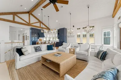 a living room with white couches and a table at Hope Town Pearl Cottage in Rosemary Beach