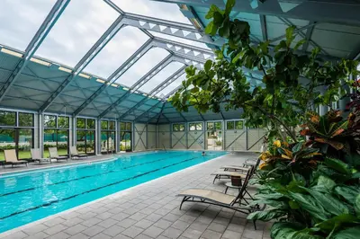 an indoor swimming pool with a glass ceiling at Bella Carriage House in Rosemary Beach