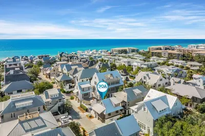an aerial view of a city with houses and the ocean at Bella Carriage House in Rosemary Beach