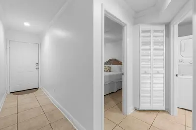 a white hallway with a bedroom with a bed at Seamist #5 in Seacrest