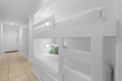 a white bunk bed in a white room at Seamist #5 in Seacrest