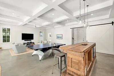 a living room with a ping pong table and a couch at 98 Sandy Shores Ct in Seacrest