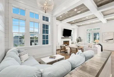 a living room with white furniture and windows at 98 Sandy Shores Ct in Seacrest