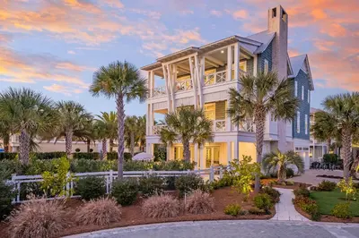 a large white house with palm trees in front of it at 98 Sandy Shores Ct in Seacrest