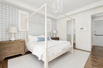 a white bedroom with a white canopy bed at 98 Sandy Shores Ct in Seacrest