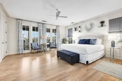 a bedroom with a bed and a table and chairs at Rose at Mercado in Rosemary Beach