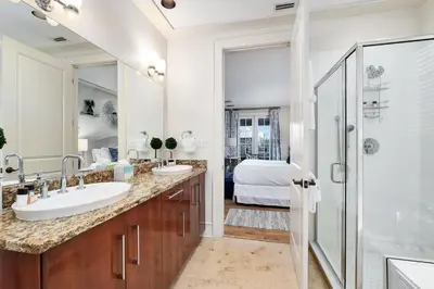 a bathroom with two sinks and a shower at Rose at Mercado in Rosemary Beach