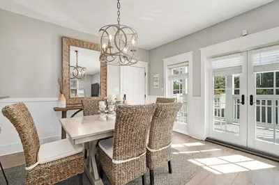 a dining room with a table and chairs at Just Breathe Flat in Rosemary Beach