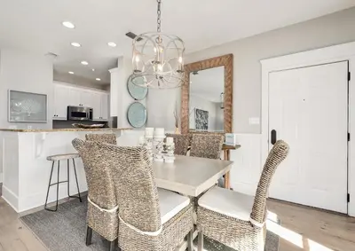 a dining room with a table and chairs at Just Breathe Flat in Rosemary Beach