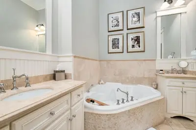 a bathroom with a tub and a sink at Joben Cottage in Rosemary Beach