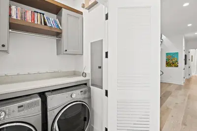 a laundry room with a washer and dryer at Oasis Cottage & Carriage House in Rosemary Beach