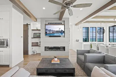 a living room with a couch and a fireplace at Oasis Cottage & Carriage House in Rosemary Beach