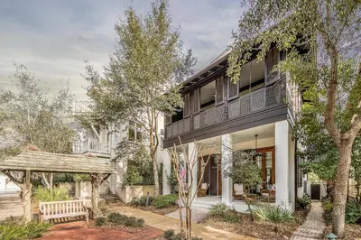 a house with a balcony on the side of it at Uncorked Cottage in Rosemary Beach