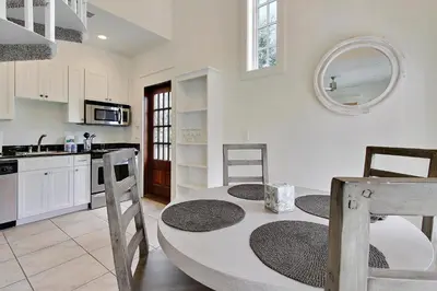 a kitchen with a table and chairs in a room at Southern Serenity Carriage House in Rosemary Beach