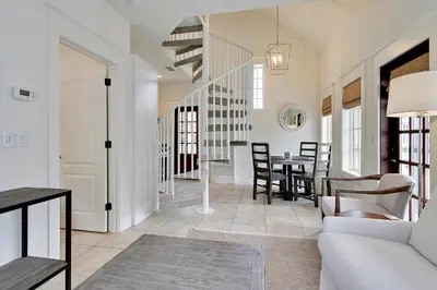 a living room with a couch and a table at Southern Serenity Carriage House in Rosemary Beach