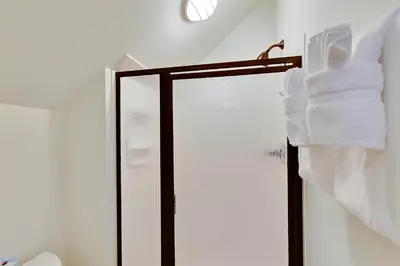 a towel rack with towels on it in a bathroom at Southern Serenity Carriage House in Rosemary Beach