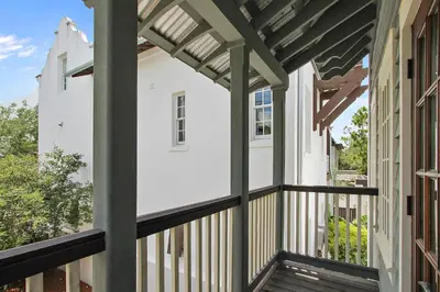 a view from the porch of a house with a pergola at Southern Serenity Carriage House in Rosemary Beach