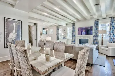 a dining room with a table and chairs at Blue Heron Cottage & Carriage House in Rosemary Beach