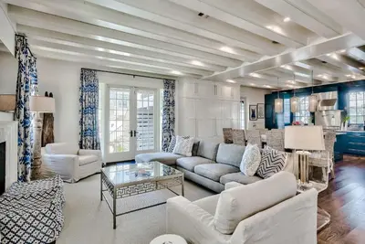 a living room with a couch and a table at Blue Heron Cottage & Carriage House in Rosemary Beach