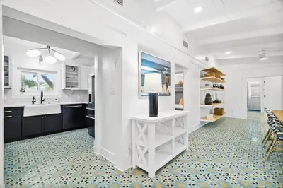 a white kitchen with a sink and a counter at Moon Tide in Seacrest