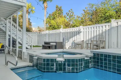a swimming pool with a patio with a white fence at Nashvilla in Seacrest