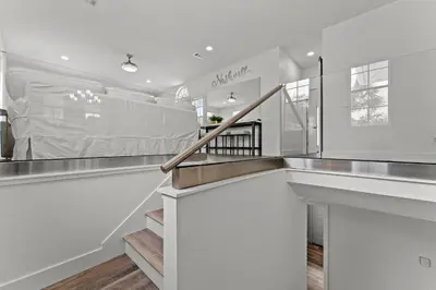 a staircase in a house with white walls at Nashvilla in Seacrest