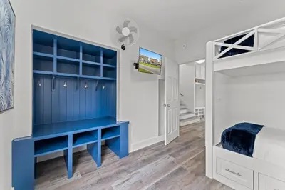 a bedroom with a blue desk and a bunk bed at Nashvilla in Seacrest