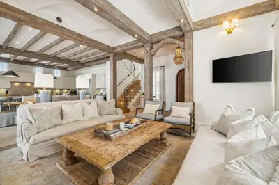 a living room with a couch and a table at Water Cottage and Carriage House in Rosemary Beach