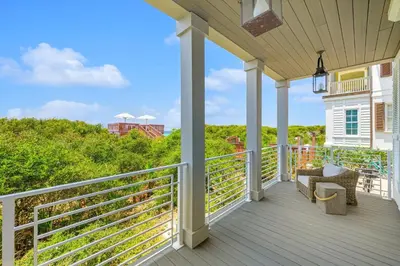 a porch with a view of the ocean at Atwoods Cottage & Carriage House in Rosemary Beach
