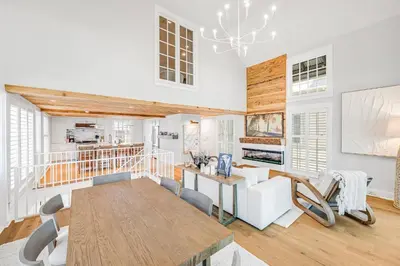 a living room with a table and a dining room at Atwoods Cottage & Carriage House in Rosemary Beach