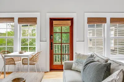 a living room with a couch and a table at Hammock Carriage House in Rosemary Beach
