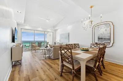 a dining room and living room with a table and chairs at High Pointe 44W in Seacrest