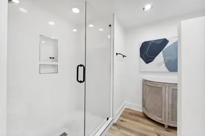a shower with a glass door in a bathroom at High Pointe 44W in Seacrest