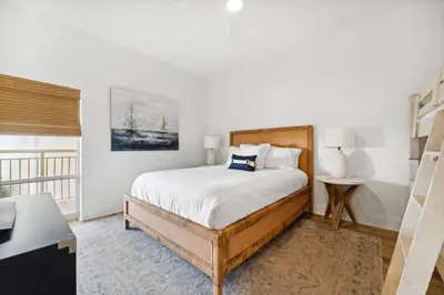 a white bedroom with a bed and a window at High Pointe 44W in Seacrest