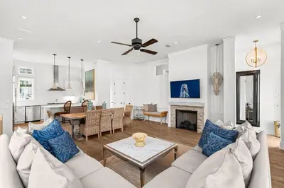 a living room with a couch and a table at Southern Seaside Cottage and Carriage House in Inlet Beach