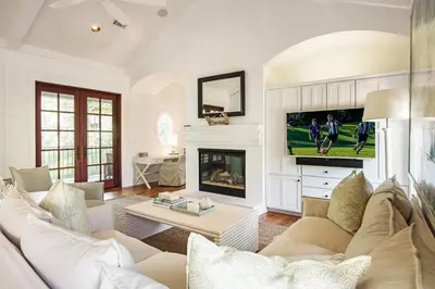 a living room with a couch and a fireplace at Hammock Cottage in Rosemary Beach