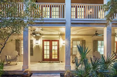 a home with a front porch with a red door at Hammock Cottage in Rosemary Beach