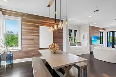 a living room with a table and a couch at Thyme & Place in Rosemary Beach