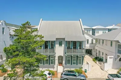 a large white house with a gray roof at Southern Serenity Cottage in Rosemary Beach