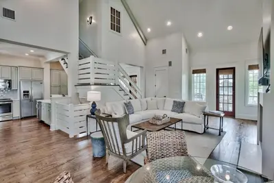 a living room with a couch and a table at Southern Serenity Cottage in Rosemary Beach